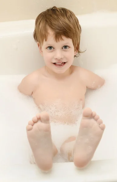 Cute three year old boy taking a bath with foam — Stock Photo, Image