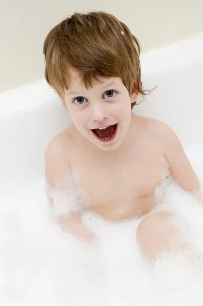 Cute three year old boy taking a bath with foam — Stock Photo, Image