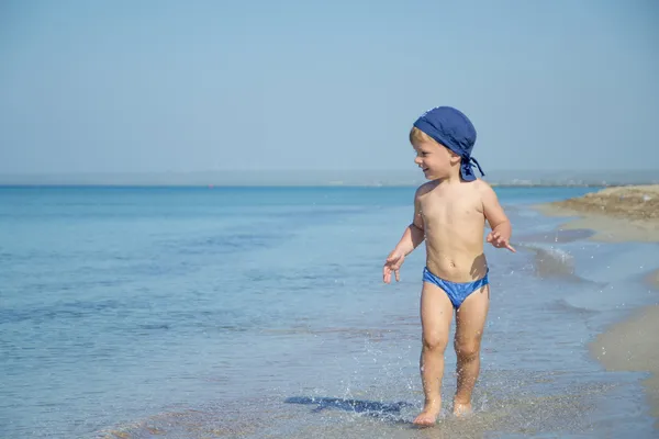 Cute child boy is running in sea — Stock Photo, Image