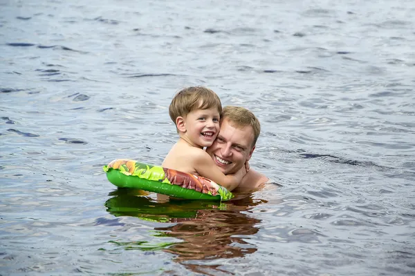 Папа и сын плавают — стоковое фото