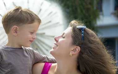 Anne ve küçük oğlu açık havada yakınındaki çeşme şehirdeki