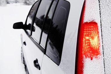 Left side of snow-covered car clipart