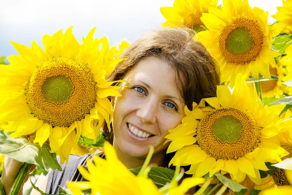 Молода красива жінка на соняшниковому полі — стокове фото