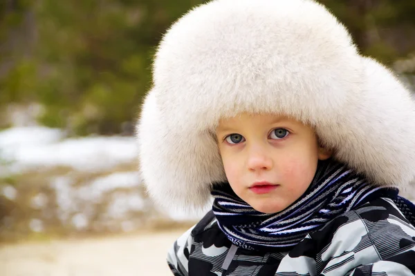 Funny cute baby boy wearing a huge winter hat — Stock Photo, Image