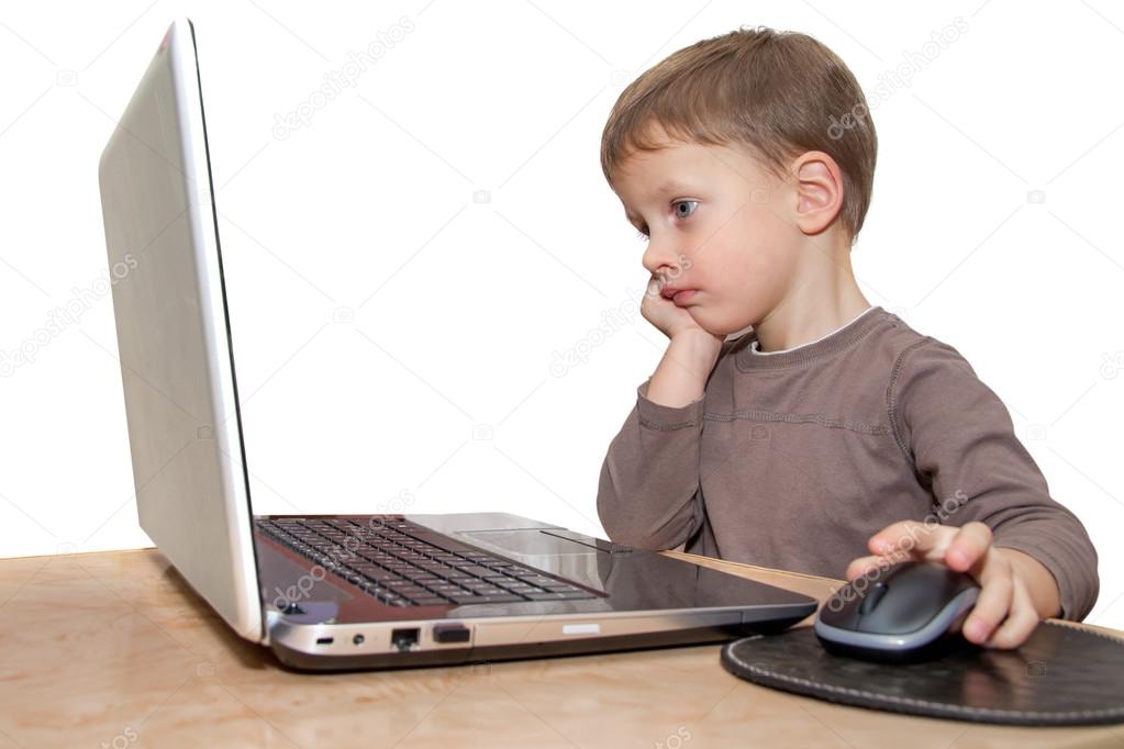 Young boy thinking in front of laptop