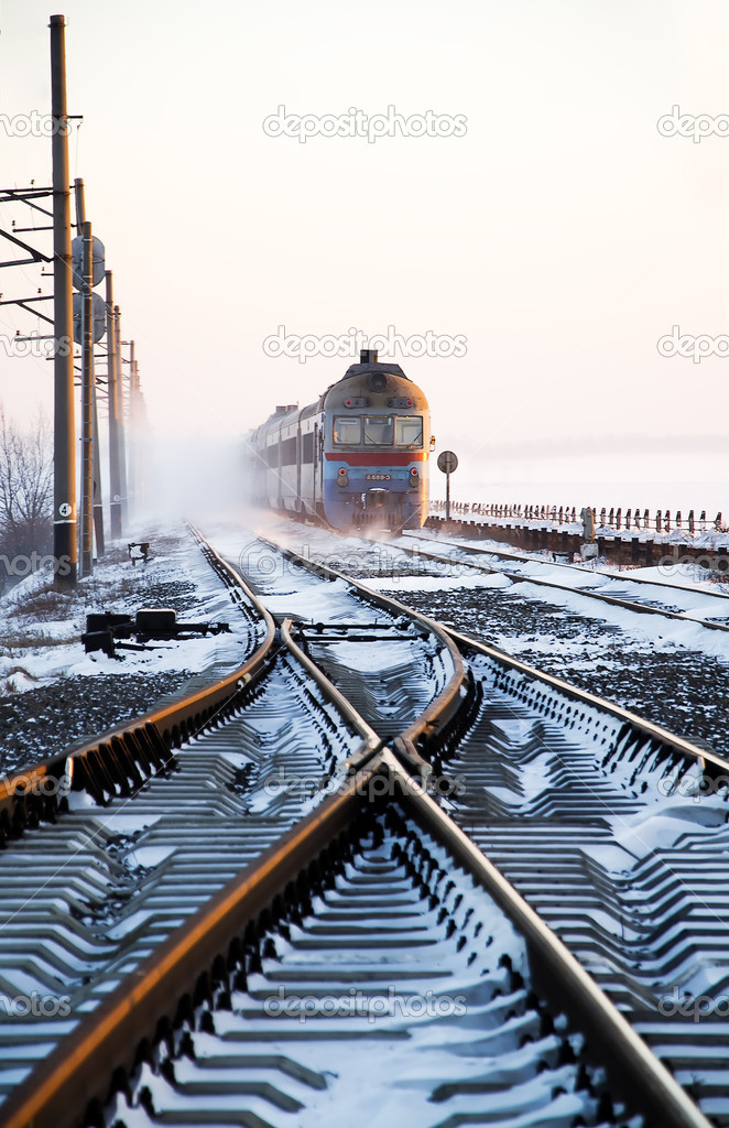 Passenger train rapidly moving along the snow track