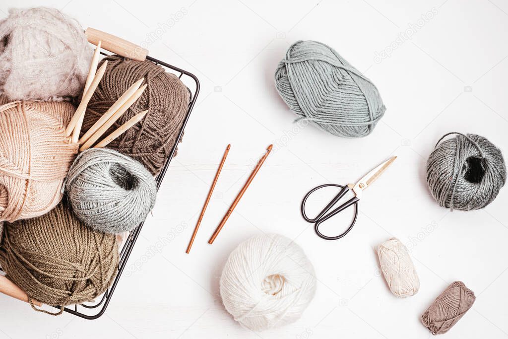 Craft hobby background with yarn in natural colors. Recomforting, destressing hobby for cold fall and winter weather. Mock up, copy space, top view