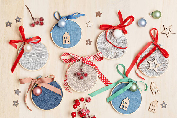 Diy project of christmas ornaments made of re-purposed old sweater, jeans and embroidery hoops. Easy handmade xmas decoration, gift idea. Flat lay, top view