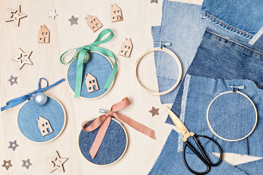 Diy project of christmas ornaments made of re-purposed old jeans and embroidery hoops. Easy handmade xmas decoration, gift idea. Upcycling concept. Flat lay, top view
