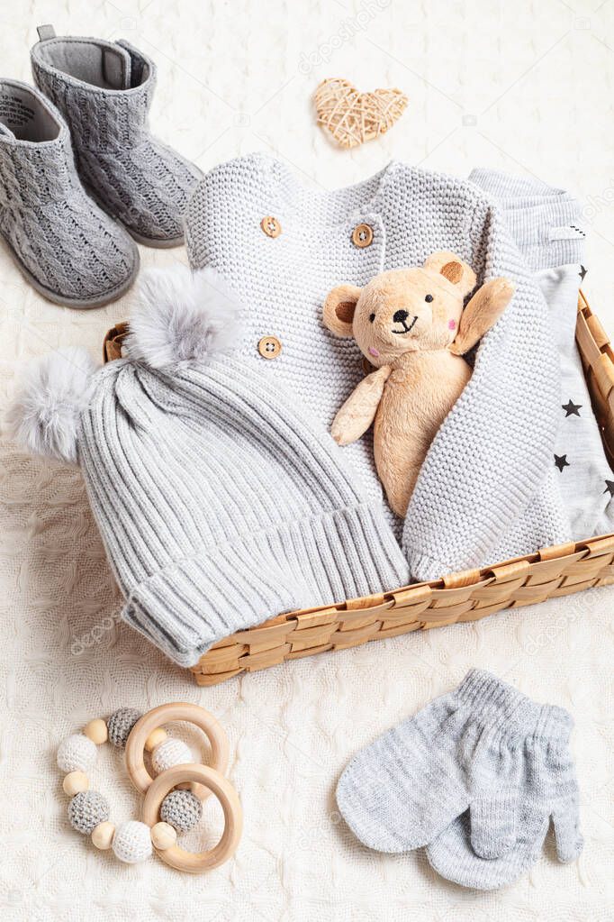 Set of cute organic baby clothes, toys and booties. Present for cold weather. Newborn gifts for Christmas and baby shower, care package, donation, charity idea