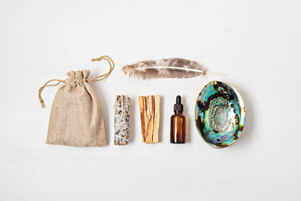 Smudge kit with white sage, palo santo, abalone sea shell. Natural elements for cleansing environment from negative energy, adding positive vibes. Spriritual practices, witchcraft concept