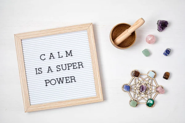 Letter board with motivation text calm is a super power. Gemstones, crystals for megitation and relax. Natural elements for cleansing negative energy, adding positive vibes. Mental health and balance concept