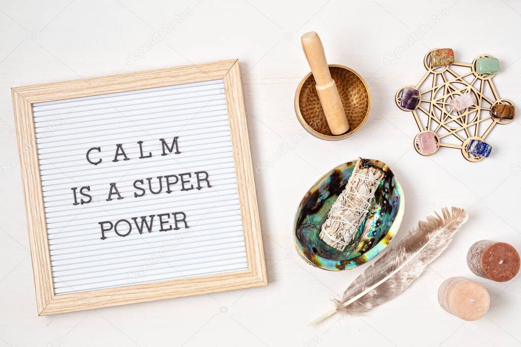 Letter board with motivation text calm is a super power. Smudge kit with white sage and gemstones, crystals. Natural elements for cleansing environment from negative energy, adding positive vibes. Mental health and balance concept