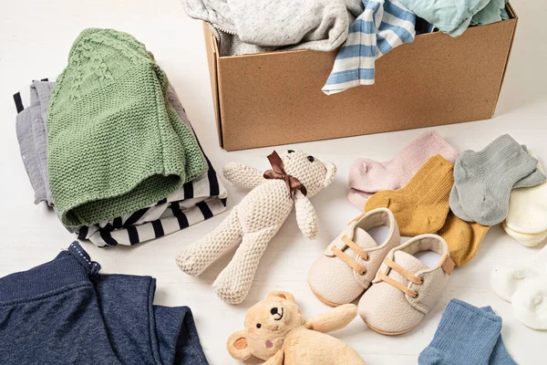 stock image Baby and child clothes, toys in box. Second hand apparel idea. Circular fashion, donation, charity concept