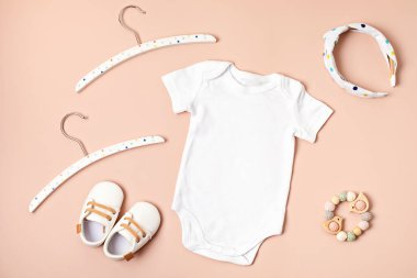 Çevre dostu bebek aksesuarlarıyla organik pamuktan yapılmış beyaz bebek tulumu. Marka, logo ve reklam için tulum şablonu. Düz yatış, üst görünüm