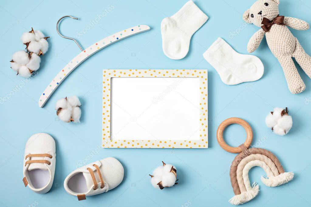 Mockup of empty frame with eco friendly baby accessories. Baby shower invitation, greeting card. Template for brand, logo, advertising. Flat lay, top view
