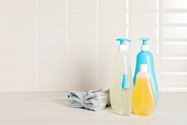Set of baby toiletries, child organic hygiene and bath accessories, shower gel, shampoo, essential oil, towel in the bathroom