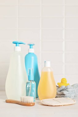 Set of baby toiletries, child organic hygiene and bath accessories, shower gel, shampoo, essential oil, towel in the bathroom