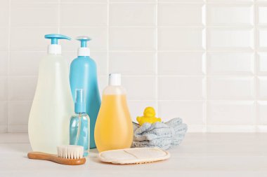 Set of baby toiletries, child organic hygiene and bath accessories, shower gel, shampoo, essential oil, towel in the bathroom