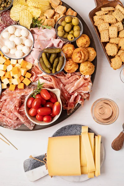 Appetizers table with different antipasti, charcuterie, snacks, cheese. Finger food for buffet party. Traditional french or italian entires. Top view