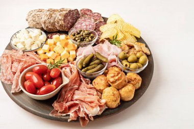 Appetizers table with different antipasti, charcuterie, snacks, cheese. Finger food for buffet party. Traditional french or italian entires. Top view