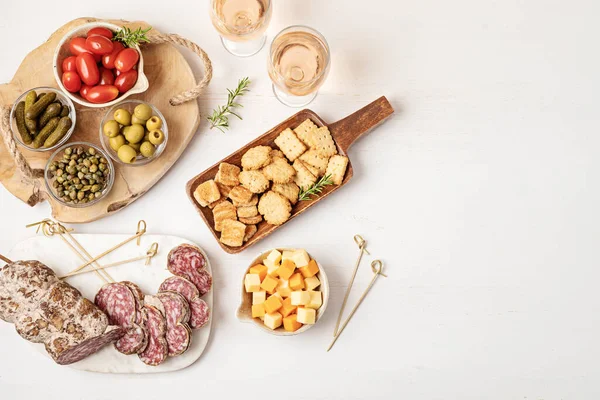 Appetizers table with different antipasti, charcuterie, snacks, cheese. Finger food for buffet party. Traditional french or italian entires. Top view