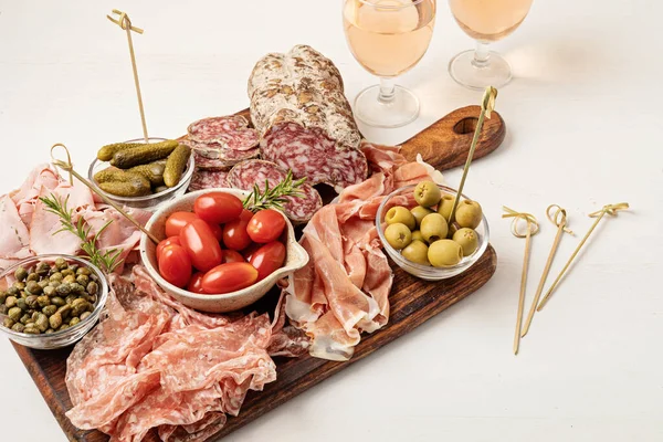 Appetizers table with different antipasti, charcuterie, snacks, cheese. Finger food for buffet party. Traditional french or italian entires. Top view