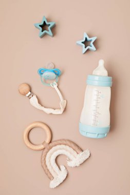 Flat lay with baby sleep accessories with milk bottles, pacifier and toys. Newborn sleeping rules concept