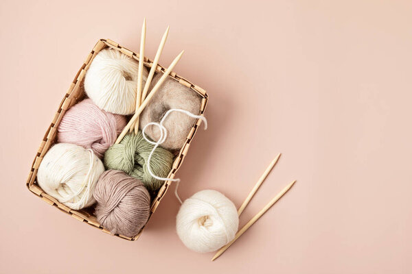 Craft hobby background with yarn in natural colors. Recomforting hobby to reduce stress for cold fall and winter weather. Mock up, copy space, top view