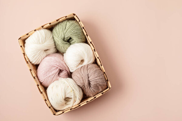 Craft hobby background with yarn in natural colors. Recomforting hobby to reduce stress for cold fall and winter weather. Mock up, copy space, top view