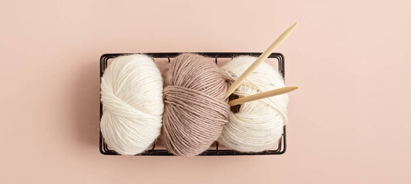 Craft hobby background with yarn in natural colors. Recomforting hobby to reduce stress for cold fall and winter weather. Mock up, copy space, top view