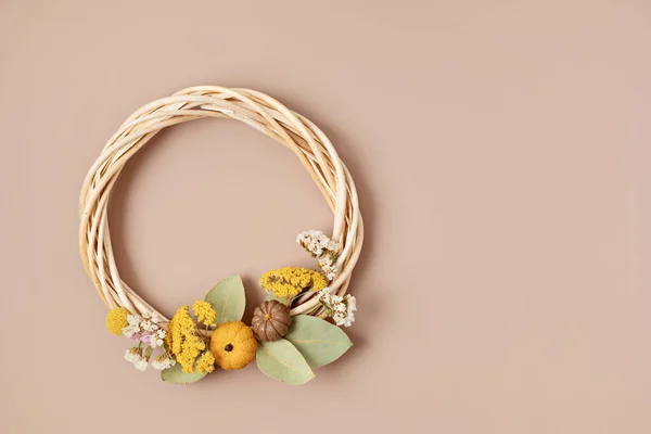 Handmade wreath with dry flowers. DIY autumn decoration idea. Artisan, small business, sustainable decor for fall holidays concept