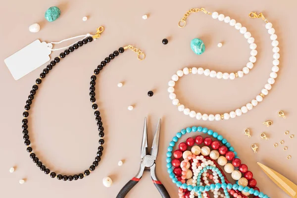 Jewelry making flatlay with semi-precious stone beads and tools. Handmade jewelry, small business, hobby concept