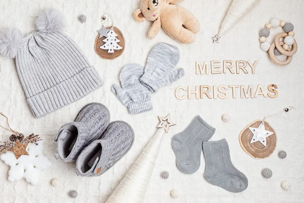 Collection of cute organic baby clothes, booties, toys. Warm outfit for cold weather. Newborn gifts for cristmas and baby shower, second hand clothes, donation idea.