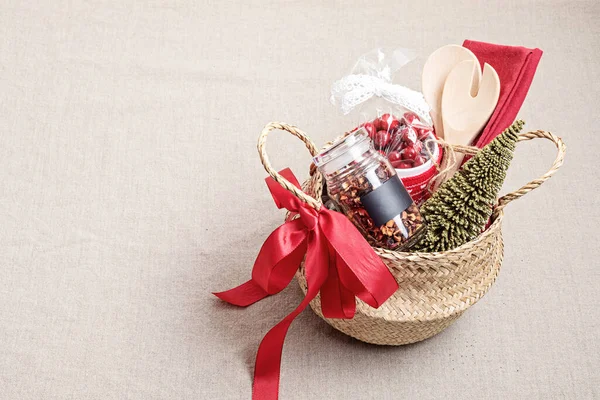 Refined Christmas gift basket for culinary enthusiats with mug, fruit tea and kitchen utensils. Corporate or personal present for cooking lovers, foodies and gourmands.