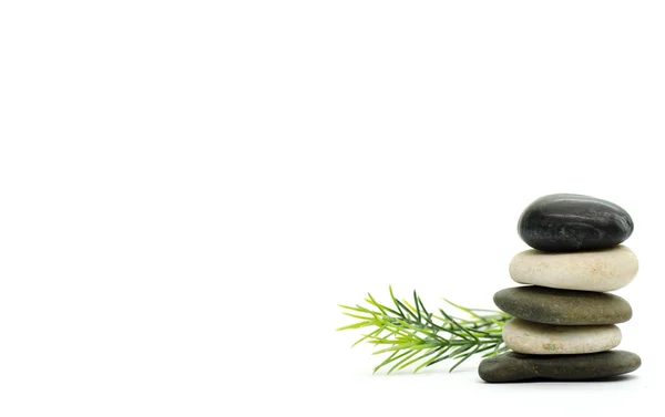 Stacked stone on white background with rosemary — Stock Photo, Image