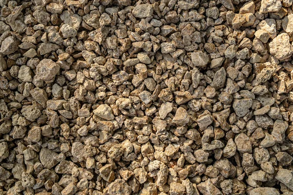 Texture of small shell rock. Background of small cobblestones and fragments of shell rock. Brown stones.