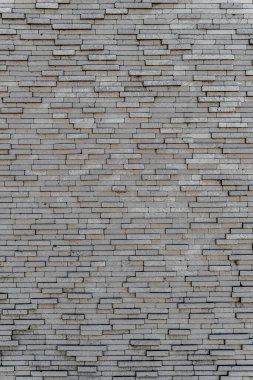 Gri tuğla duvar. Farklı boyutlarda dikdörtgen gri fayansların arka planı. Geometrik doku.