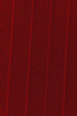 Red background of wavy metallic grid with holes. Metal mesh as background. Perforated metal back.  clipart