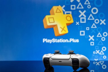 May 2, 2020, Odessa, Ukraine. White new Playstation 5 gamepad with Playstation Plus on screen, selective focus. Blue background.