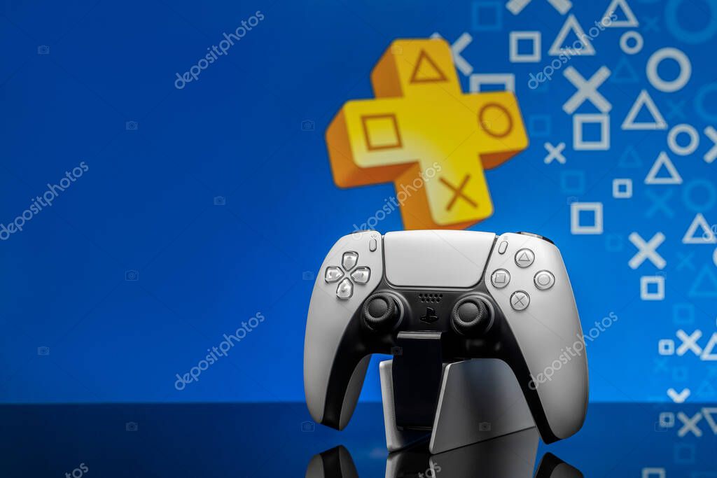 May 2, 2020, Odessa, Ukraine. White new Playstation 5 gamepad with Playstation Plus on screen, selective focus. Blue background.