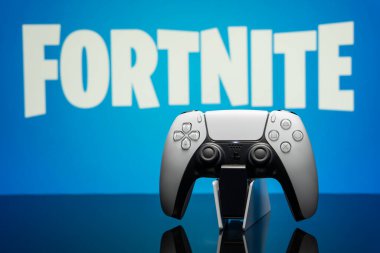 May 16, 2022, Odessa, Ukraine. White new Playstation 5 gamepad on the background of the game fortnite. Fortnite cybersport poster concept.