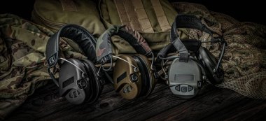 Ahşap bir yüzeyde koruyucu kulaklıklar. Güvenlik ekipmanları. Gürültü azaltmak için kulaklık. Koyu arkaplan.