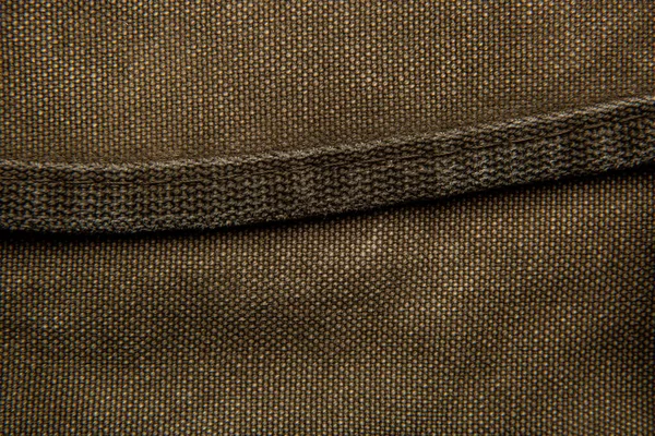 帆布背包的特写纹理 皮革带和金属扣 古旧土黄色背景 — 图库照片