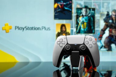 August 7, 2022, Odessa, Ukraine. White new Playstation 5 gamepad with Playstation Plus on screen, selective focus. Light background.