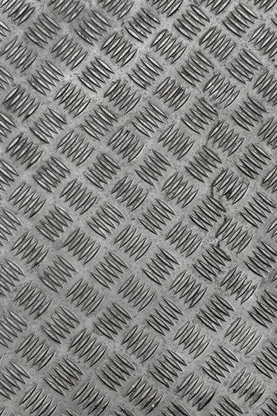 Metal surface with diamond plate texture. The diamond steel metal sheet.  Pattern of old metal diamond plate