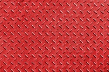 Red metal surface with diamond plate texture. The diamond steel metal sheet.  Pattern of old metal diamond plate