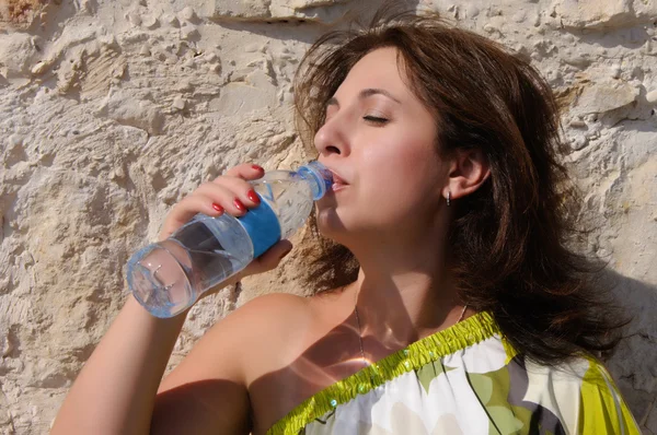 Woman drinking water from the bottle outdoor — Stock Photo, Image