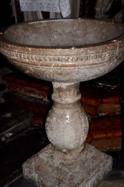 Baptismal font in the christian church. Baptismal font made of stone in historical church.