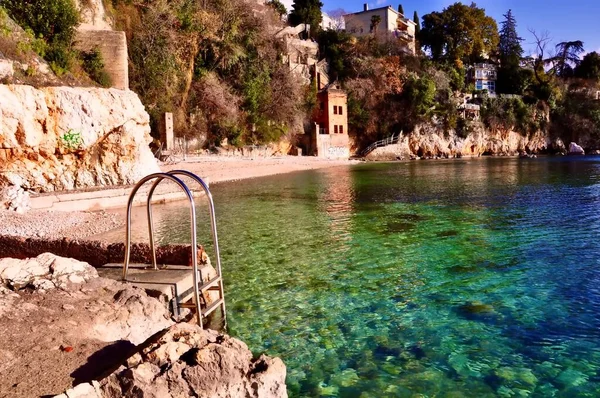 Calm beach with iron stairs to enter the sea. deserted Croatian sandy beach and the crystal clear Adriatic Sea. Glavanovo beach near Rijeka city.